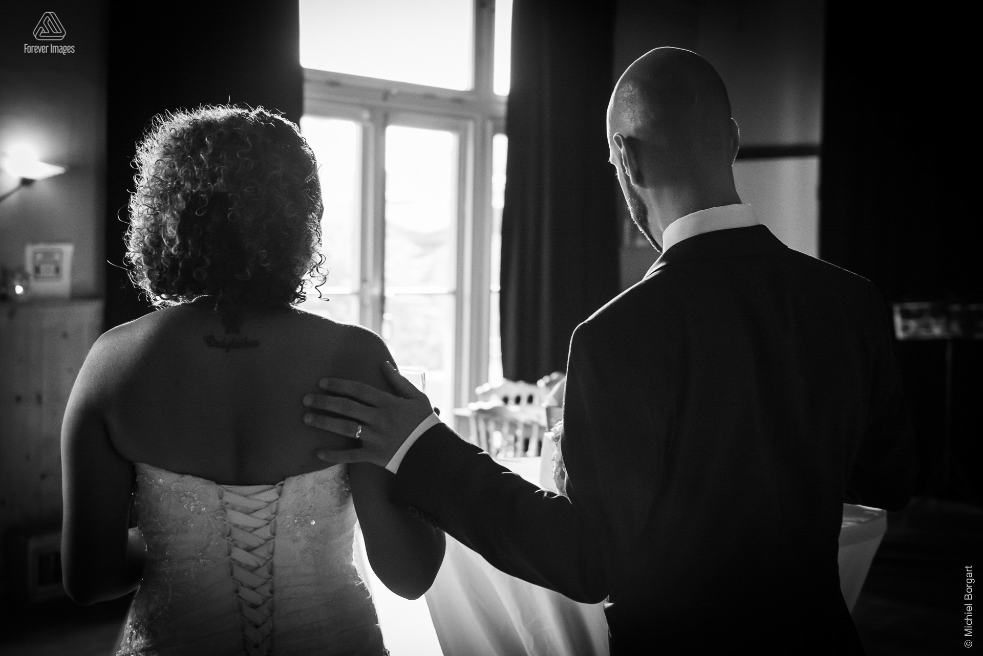 Bridal photo black and white B&W together towards the light | Kamiel Elseric | Wedding Photographer Michiel Borgart - Forever Images.