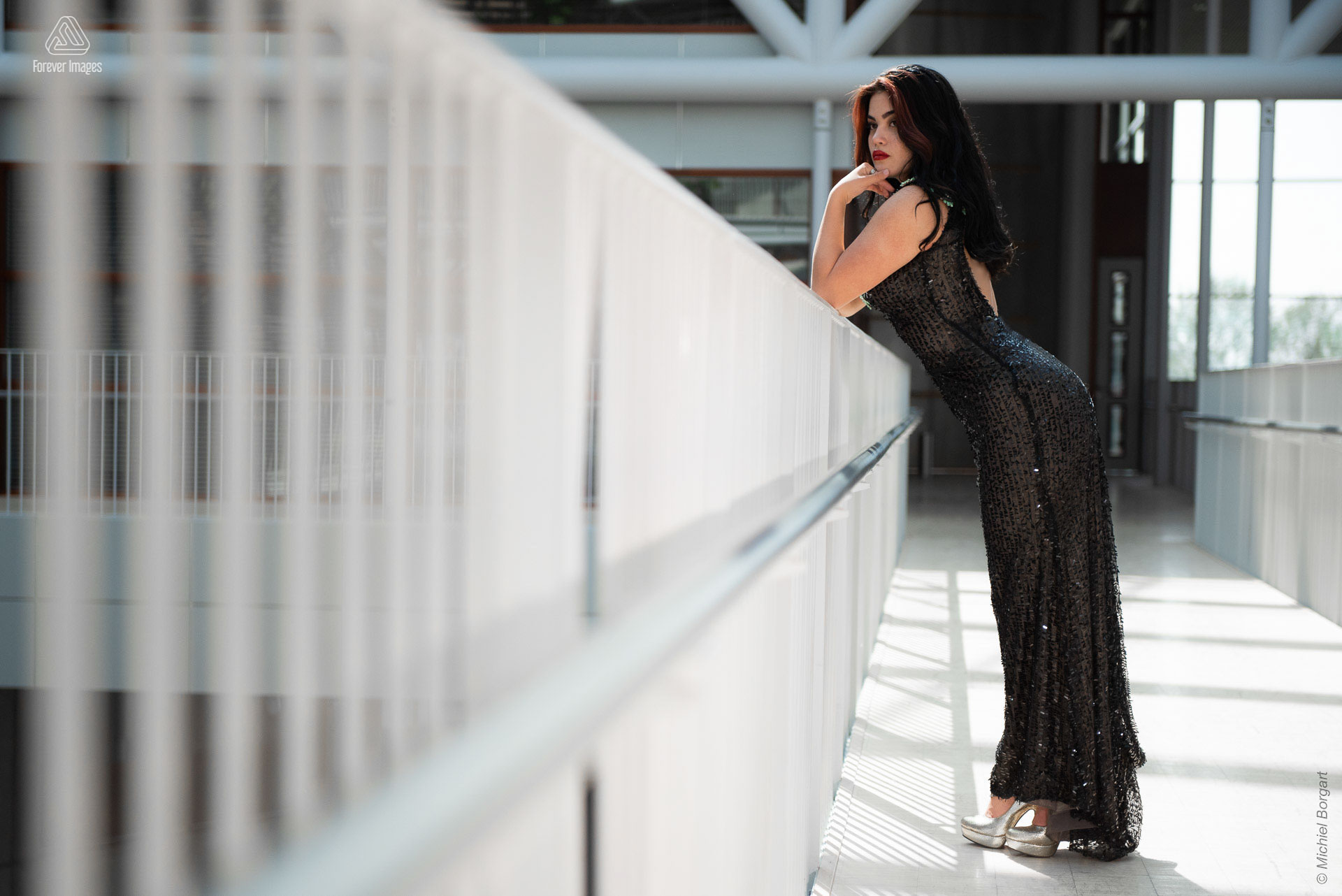 Fashion photo glamor lady leaning on railing black dress | Daphna Akkermans David Cardenas | Fashion Photographer Michiel Borgart - Forever Images.