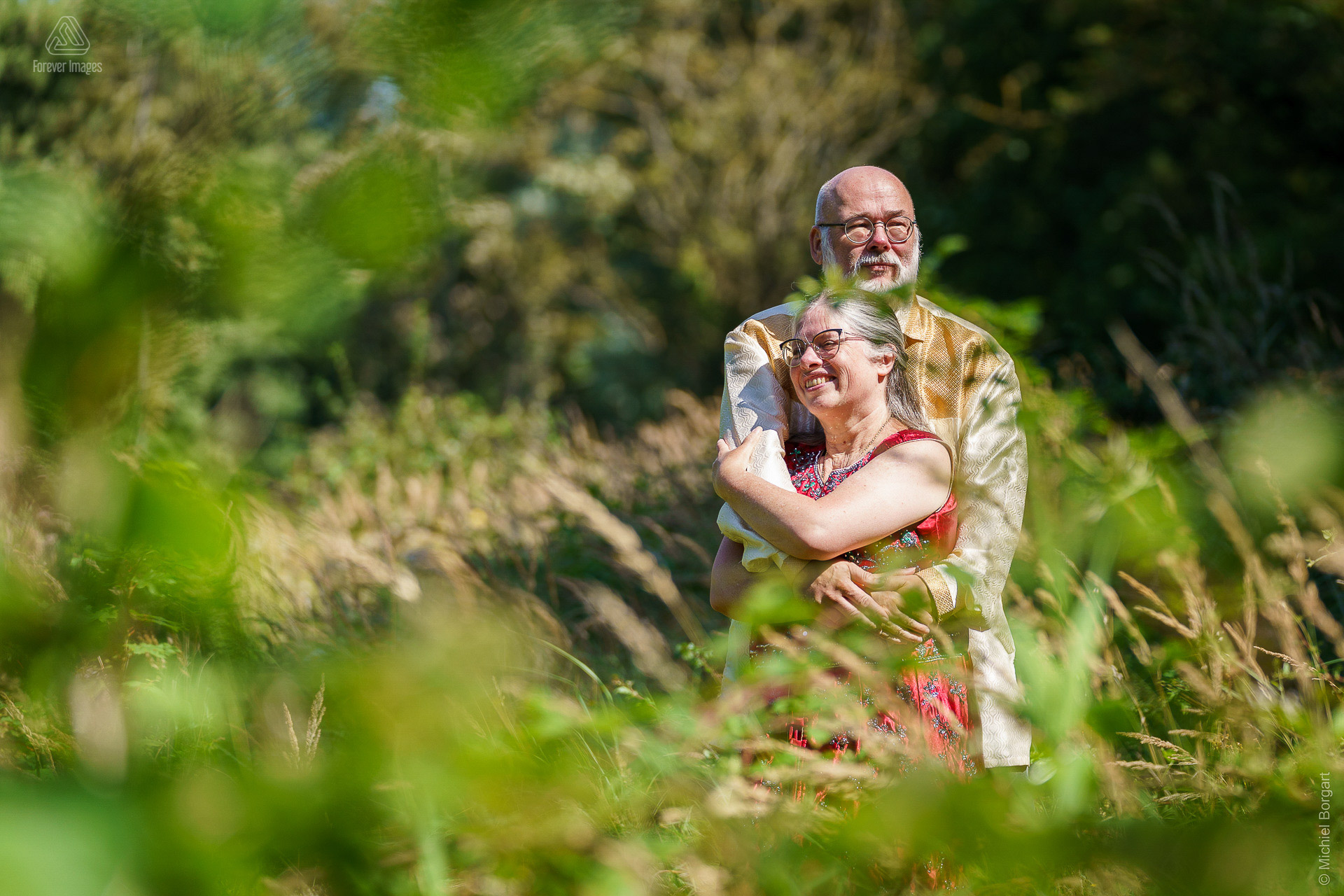 Portrait photo happy couple enjoying the sun between green vegetation | Henk | Portrait Photographer Michiel Borgart - Forever Images.