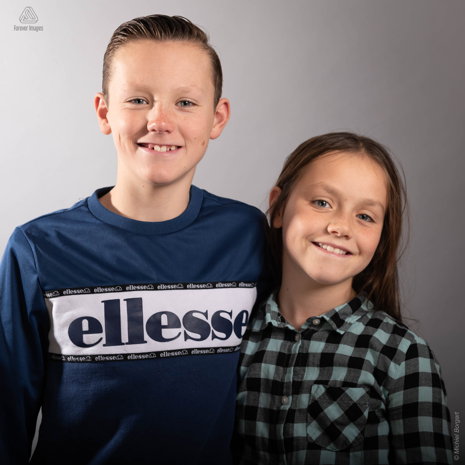 Portrait photo of a big brother with sister by his side | Portrait Photographer Michiel Borgart - Forever Images.