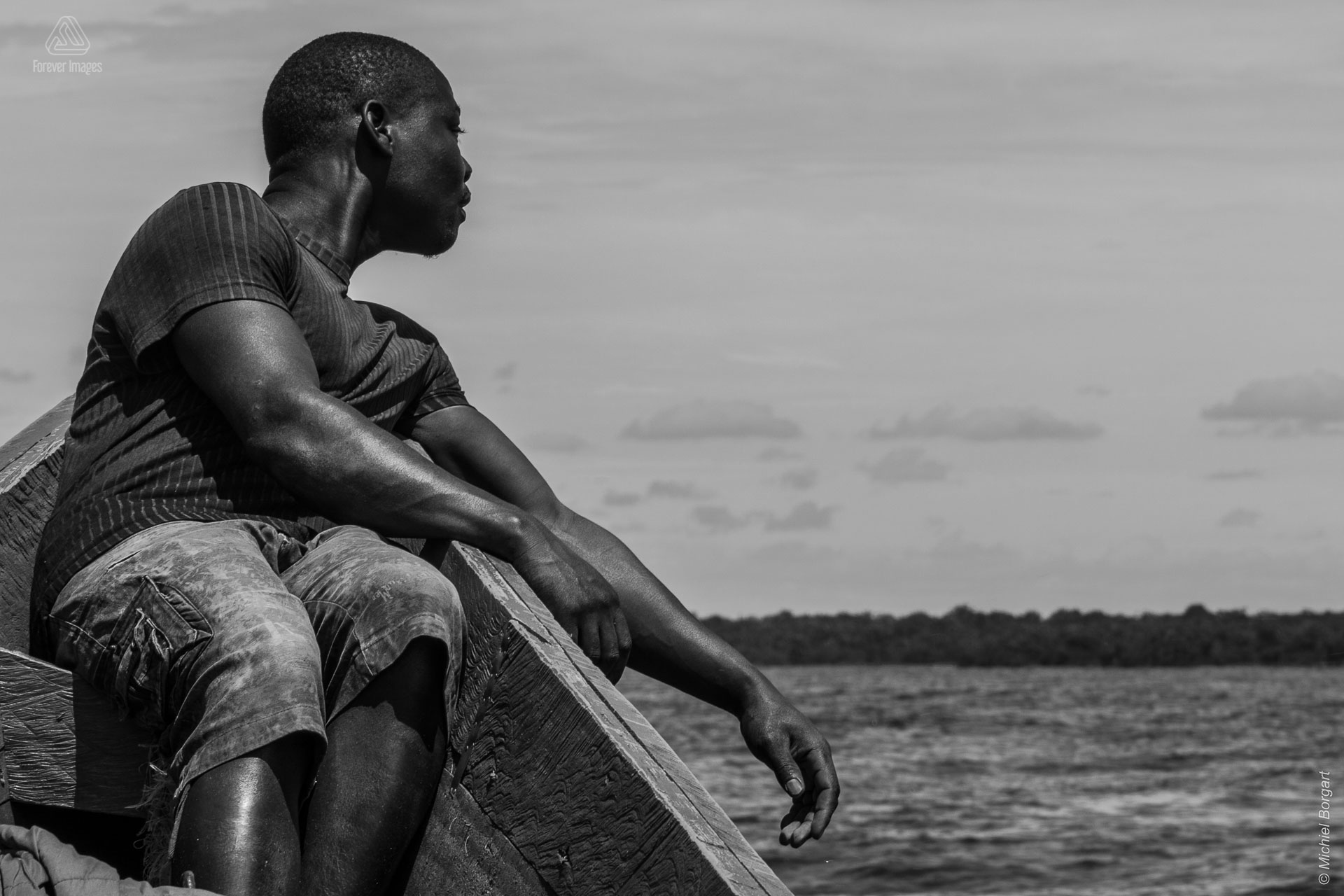 black and white B&W portrait photo of a man in a boat in Uganda during the 2015 Muskathlon | Portrait Photographer Michiel Borgart - Forever Images.