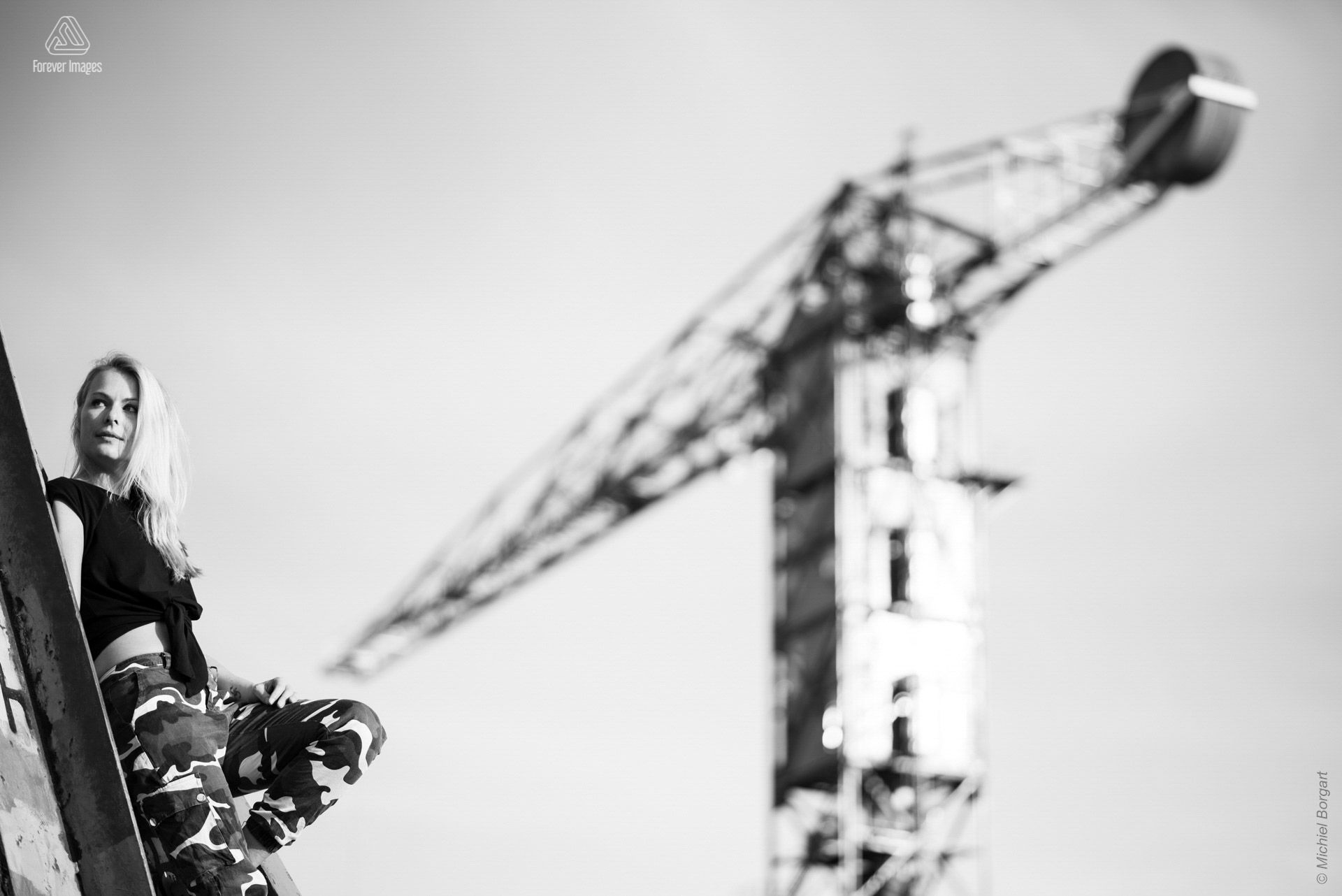 Portrait photo black and white B&W lady on steel construction with crane | Heleen Muchachabiker NDSM Werf | Portrait Photographer Michiel Borgart - Forever Images.
